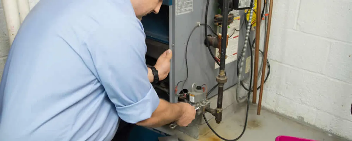 Furnace repair technician inspecting and servicing a home heating system in Easton, PA