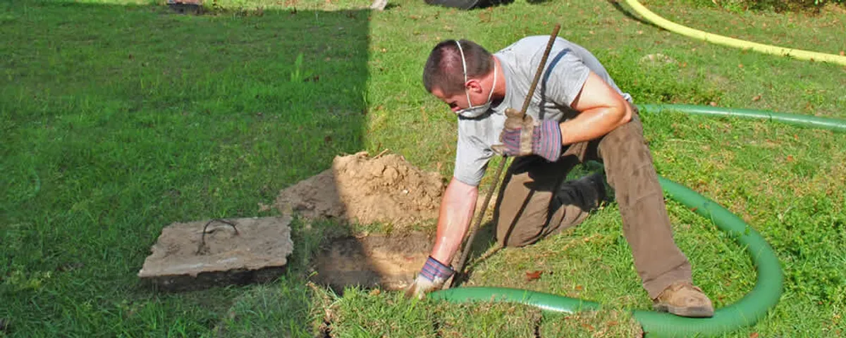 Septic pumping technician servicing a residential septic tank in Easton, PA